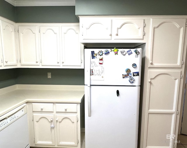 kitchen featuring tile patterned floors, white appliances, white cabinetry, and crown molding