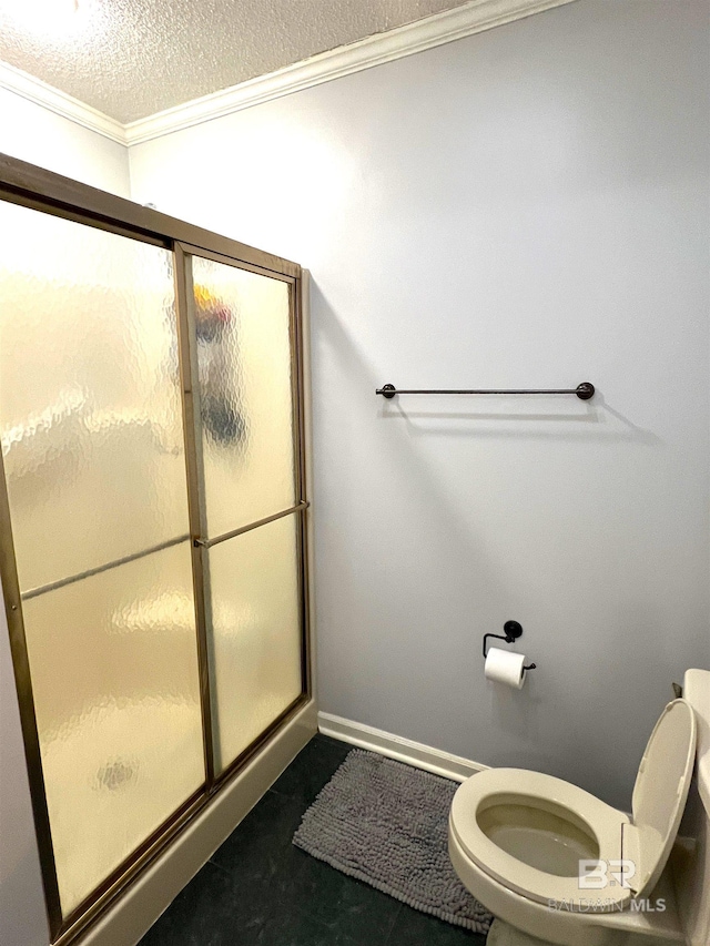 bathroom featuring a textured ceiling, walk in shower, and toilet