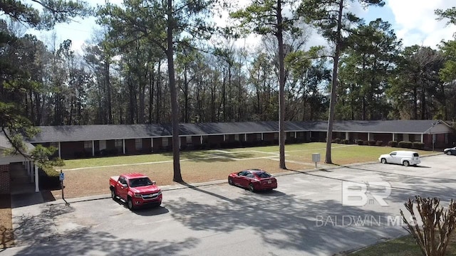 view of car parking with a lawn