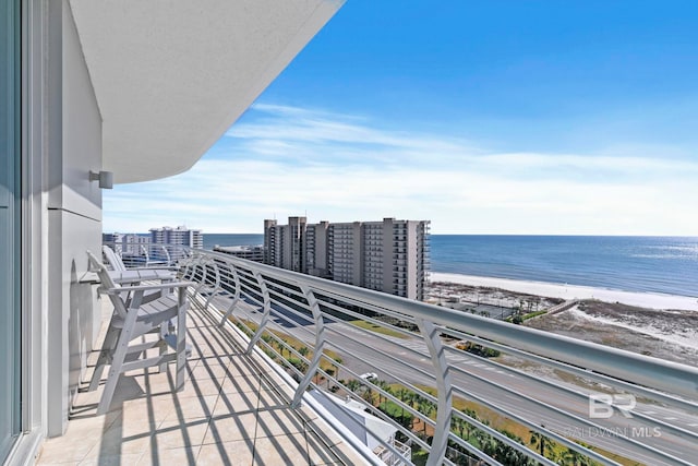 balcony with a water view and a beach view