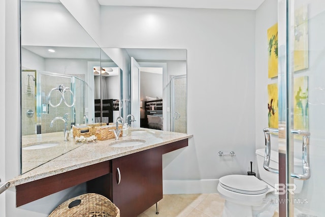 bathroom with toilet, vanity, tile patterned flooring, and a shower with door