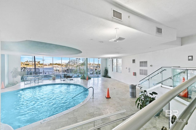 view of swimming pool with a water view