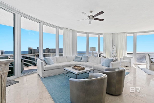 sunroom / solarium featuring ceiling fan, a water view, and plenty of natural light