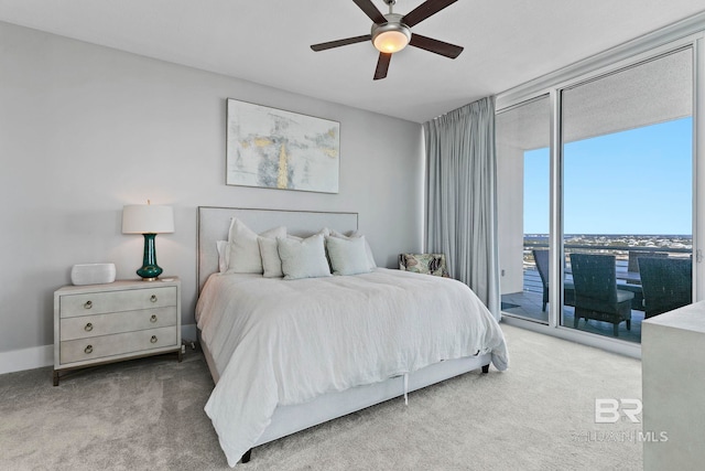 carpeted bedroom featuring ceiling fan, access to outside, and floor to ceiling windows