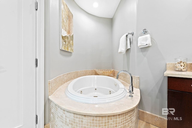 bathroom with a washtub and vanity