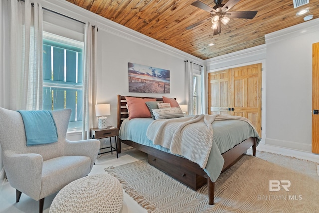 bedroom featuring wood ceiling, ornamental molding, and baseboards