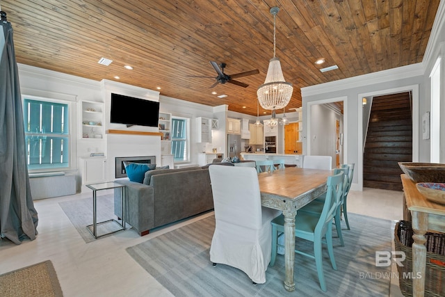 dining room with recessed lighting, crown molding, a glass covered fireplace, and wood ceiling