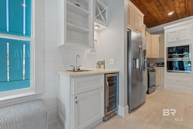 kitchen featuring decorative backsplash, stainless steel appliances, a sink, beverage cooler, and wooden ceiling