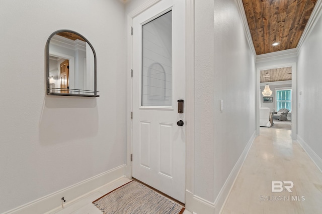 entrance foyer featuring light wood finished floors, baseboards, crown molding, and wooden ceiling