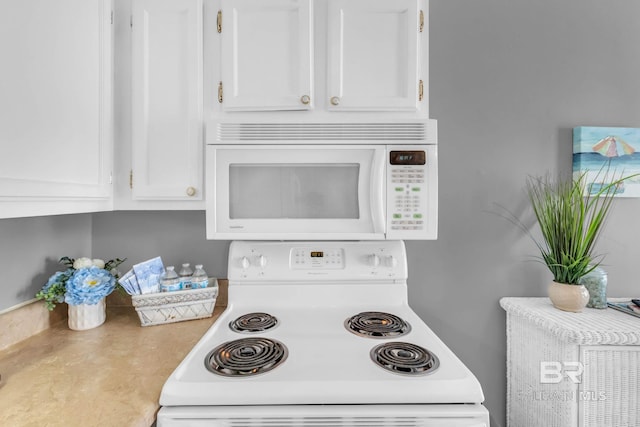 1118 W Beach Blvd Unit 4, Gulf Shores, AL 36542 - kitchen featuring white appliances, white cabinets, and light countertops