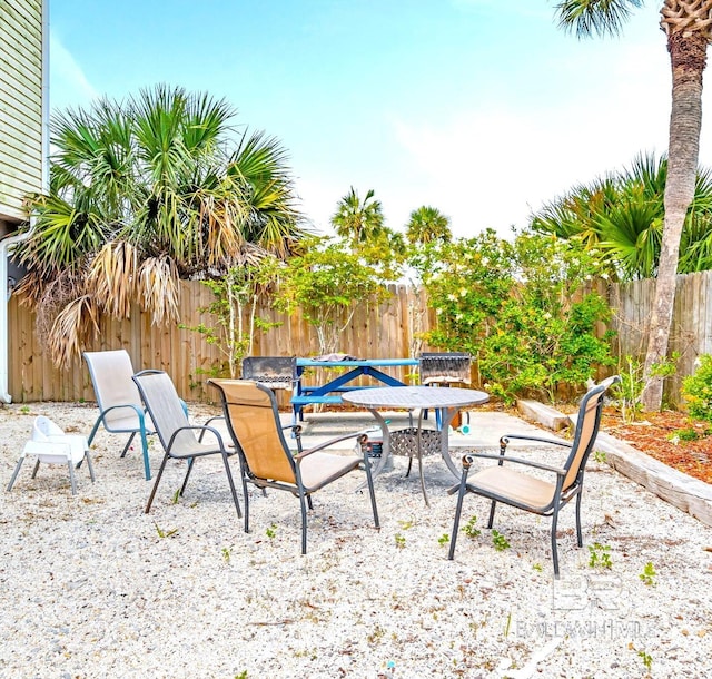 1118 W Beach Blvd Unit 4, Gulf Shores, AL 36542 - fenced backyard with a patio and outdoor dining area
