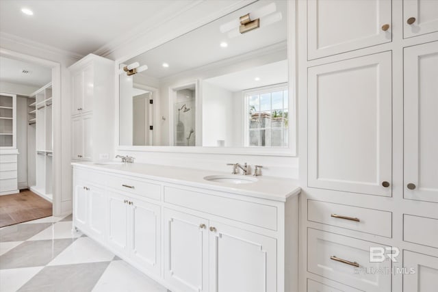 bathroom with crown molding, vanity, and an enclosed shower