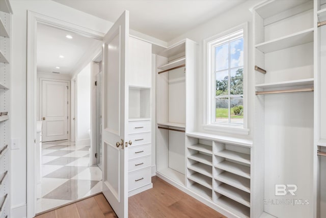 spacious closet featuring light hardwood / wood-style floors