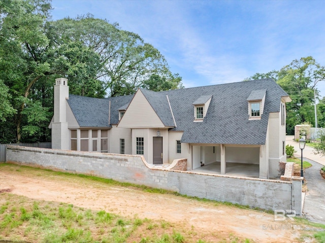 rear view of property with a garage