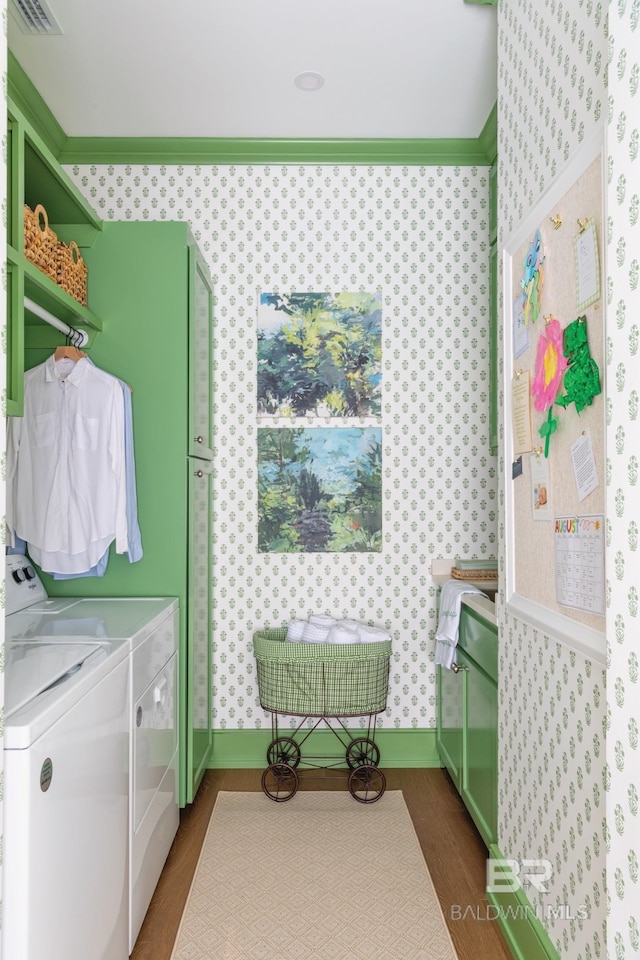 clothes washing area with dark hardwood / wood-style flooring and washing machine and dryer