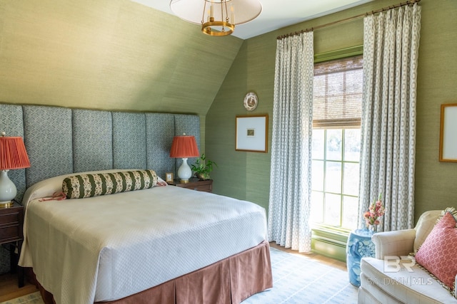 bedroom with vaulted ceiling and light hardwood / wood-style floors