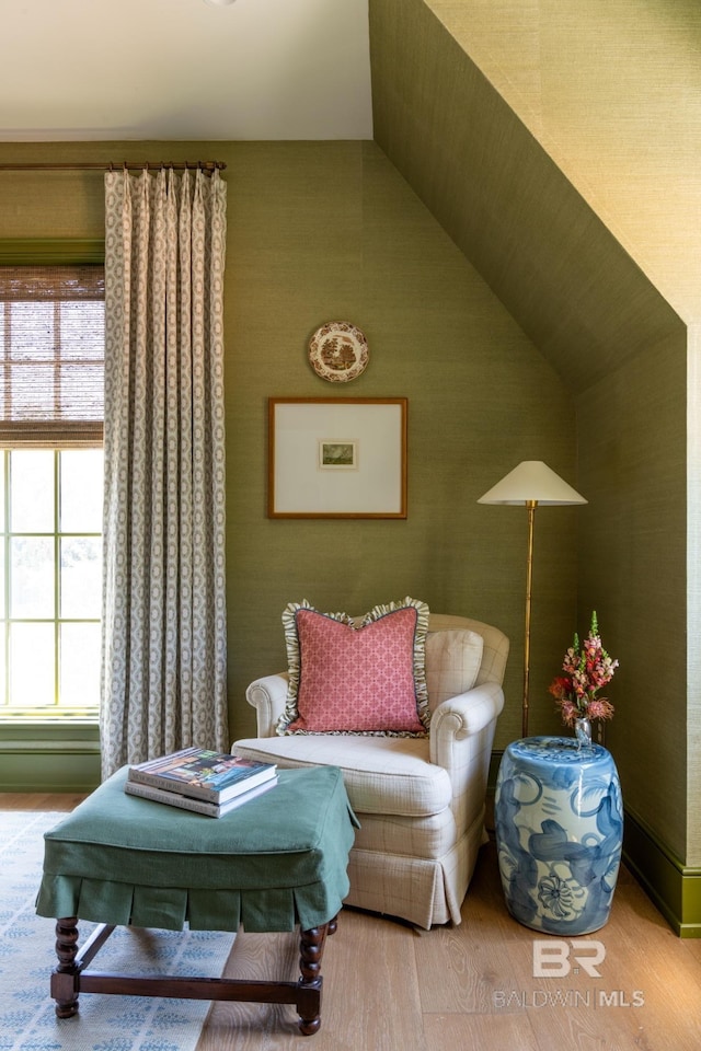 living area with wood-type flooring and lofted ceiling