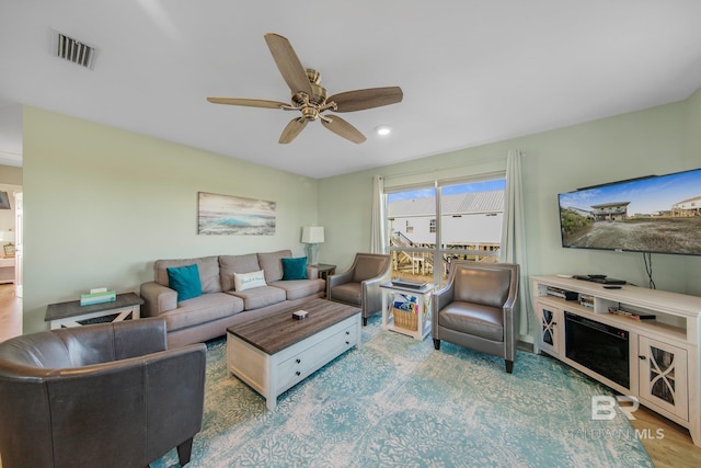 living room featuring ceiling fan and wood-type flooring