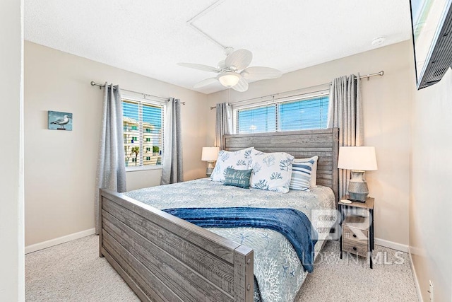 bedroom with baseboards, ceiling fan, carpet, and a textured ceiling