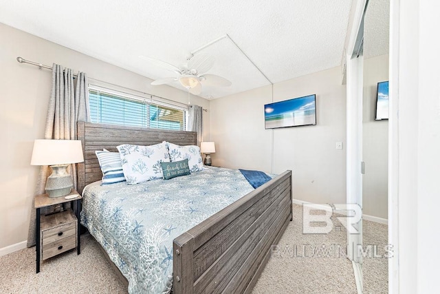 bedroom featuring baseboards, carpet flooring, a textured ceiling, and ceiling fan