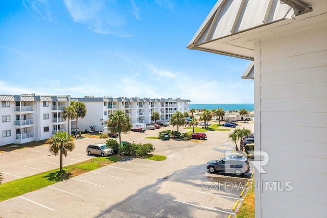 exterior space with a water view and uncovered parking