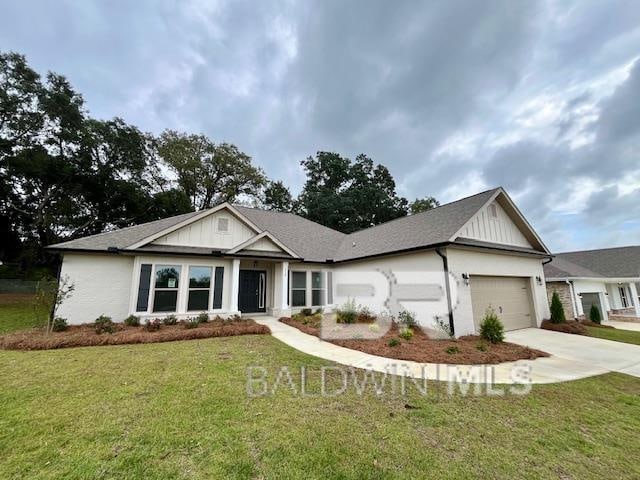 view of front of property with a garage and a front lawn