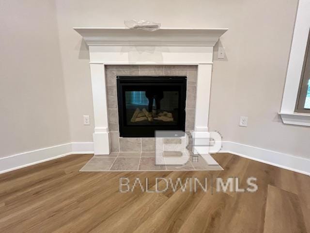 room details featuring hardwood / wood-style floors and a tile fireplace