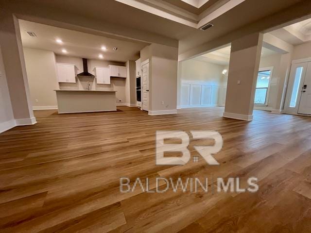 unfurnished living room with hardwood / wood-style flooring