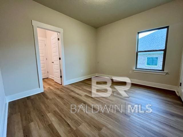 unfurnished room featuring wood-type flooring