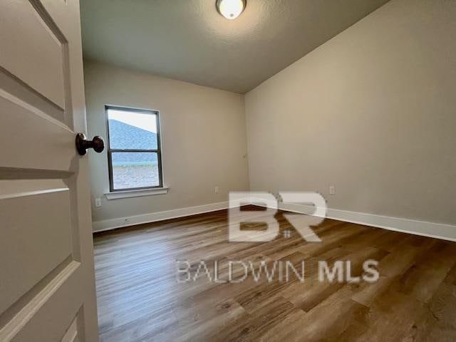 empty room featuring dark hardwood / wood-style flooring