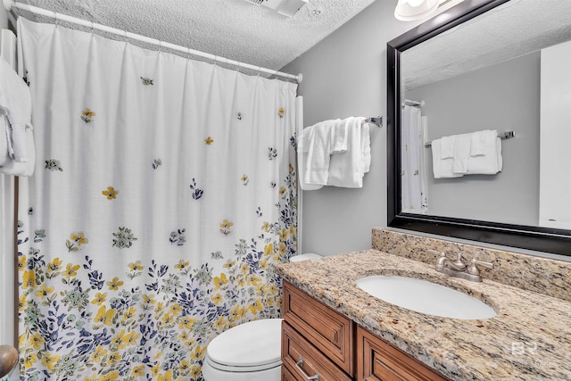 full bath with visible vents, curtained shower, toilet, vanity, and a textured ceiling