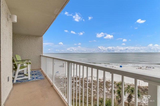 balcony with a beach view and a water view