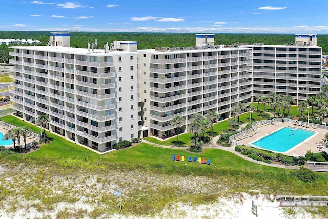 view of building exterior featuring a community pool