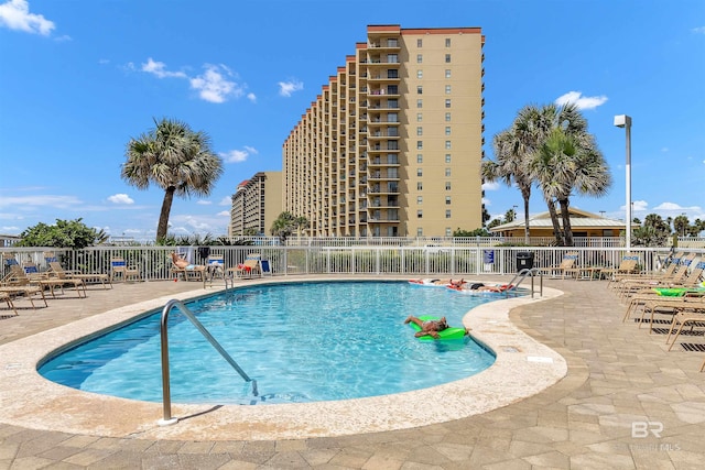 pool featuring a patio area and fence