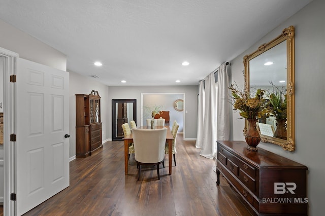 dining room with dark wood-style flooring, baseboards, and recessed lighting