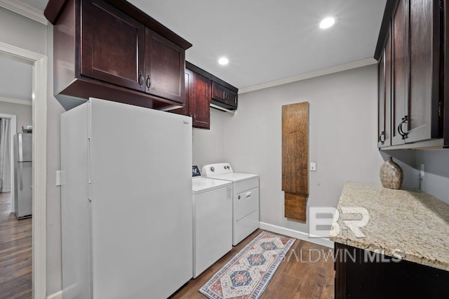 laundry area with recessed lighting, ornamental molding, dark wood-type flooring, washing machine and clothes dryer, and laundry area