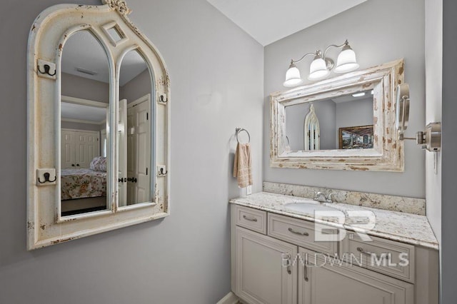 bathroom with ensuite bathroom, vanity, and visible vents