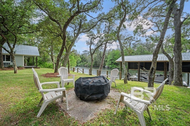 view of yard featuring a fire pit and a water view