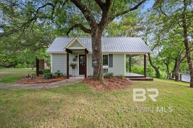 ranch-style home with covered porch, metal roof, and a front yard