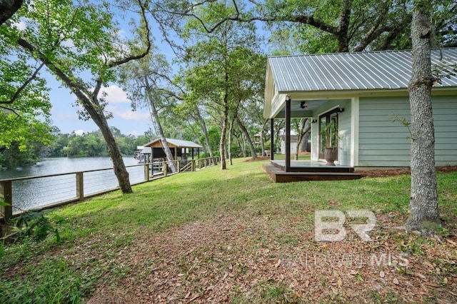 view of yard featuring a water view and fence