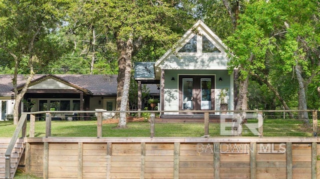 view of front of property with a fenced front yard, french doors, and a front yard