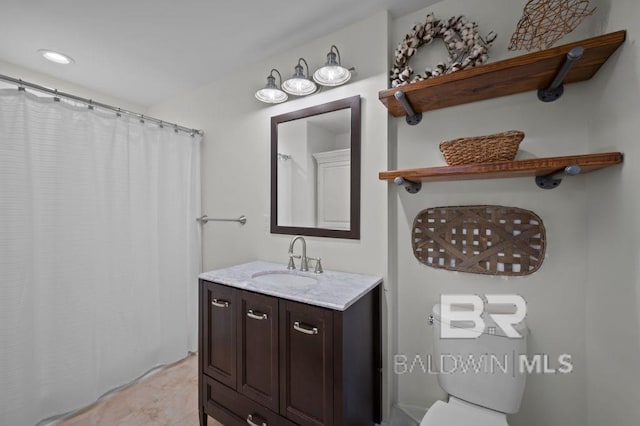 full bathroom with toilet, vanity, and recessed lighting