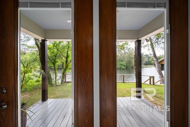 doorway to outside featuring a water view and wood-type flooring