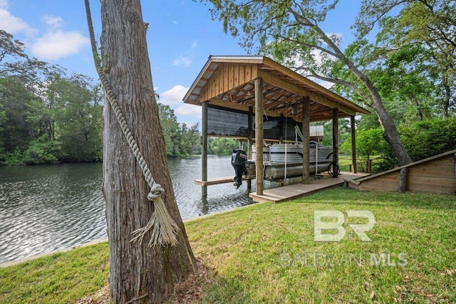 dock area featuring boat lift, a yard, and a water view