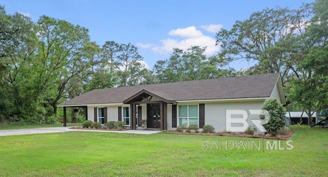 view of front of property with a front lawn, brick siding, and driveway