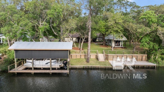 dock area with a yard, fence, and a water view