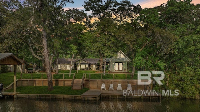 exterior space featuring a water view and a lawn