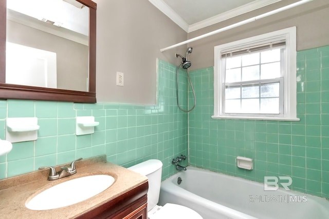 full bathroom with crown molding, tile walls, toilet, vanity, and  shower combination