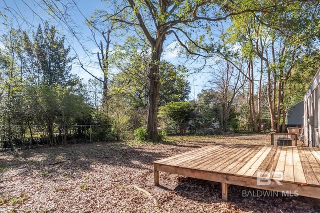 view of yard featuring fence and a wooden deck