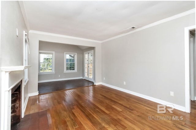 unfurnished living room featuring a fireplace, visible vents, baseboards, hardwood / wood-style floors, and crown molding